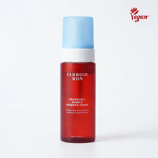 A bottle of Terroir Bon Grapecell Bubble Essence Toner with a translucent red bottle, a white neck, and a light blue cap, shown on a white background with a red Vegan logo in the top right corner.